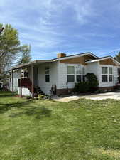 Beautifully maintained home and yard with offstreet parking, carport, outdoor retreat and two large sheds/workshops.