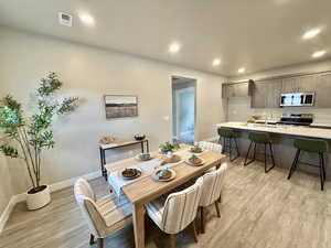Dining area featuring recessed lighting and light wood-style floors