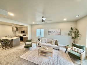 Living room featuring recessed lighting, a ceiling fan, light carpet, and a textured ceiling