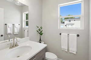 Half bath featuring vanity and toilet