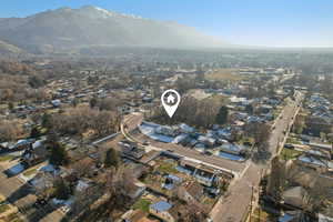 Aerial view of property's location featuring nearby suburban area and a mountainous background