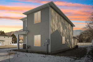 Snow covered house featuring a mountain view