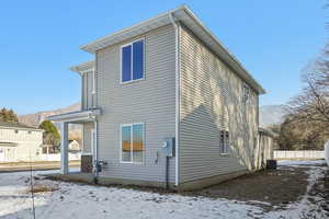 Snow covered house featuring a mountain view