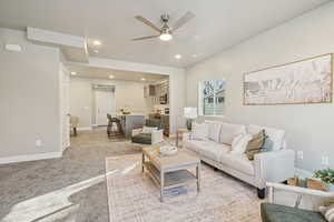 Living room featuring ceiling fan, light colored carpet, and recessed lighting