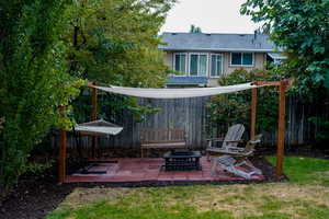 View of yard featuring a fire pit and a patio area