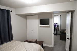 Bedroom featuring carpet and a closet