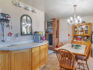 Dining area featuring a textured ceiling and a chandelier