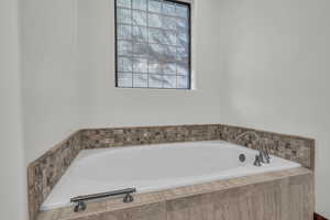 Full bathroom featuring a bath