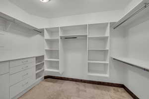 Spacious closet featuring light stone finish flooring