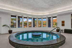 View of pool with an indoor hot tub and a pool