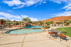Community pool featuring a patio and a mountain view