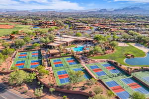 Drone / aerial view of a water and mountain view and a local golf course