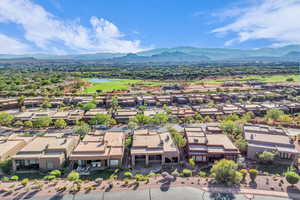 Aerial view of residential area with a water and mountain view and a golf course