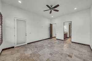 Unfurnished bedroom with stone tile flooring, recessed lighting, a ceiling fan, and ensuite bathroom