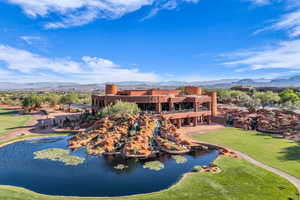Drone / aerial view of a water and mountain view and a golf course