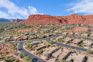 Aerial view of property and surrounding area with a mountain backdrop and nearby suburban area