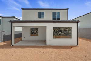 Rear view of house featuring stucco siding