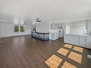 Unfurnished living room featuring dark wood finished floors and a textured ceiling