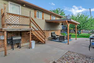 View of patio featuring stairs, a grill, a ceiling fan, and an outdoor hangout area