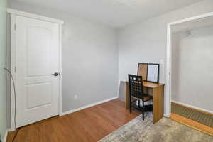 Office with baseboards and wood finished floors