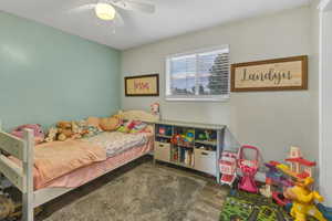 Bedroom with dark wood-style floors and a ceiling fan