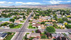 Aerial view of property's location featuring nearby suburban area and a mountainous background