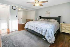 Bedroom featuring dark wood-style flooring and a ceiling fan