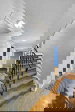 Stairway featuring wood finished floors and baseboards