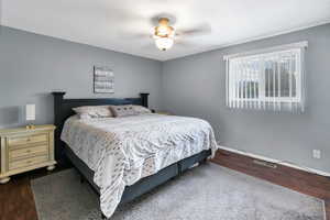 Bedroom with dark wood-style flooring and ceiling fan
