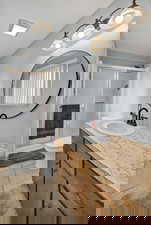 Bathroom featuring vanity, a stall shower, and light tile patterned flooring