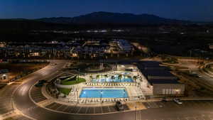 Aerial view at night of a mountain view and view of pool