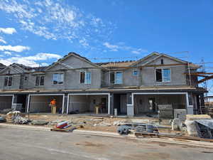Unfinished property featuring stucco siding and a patio