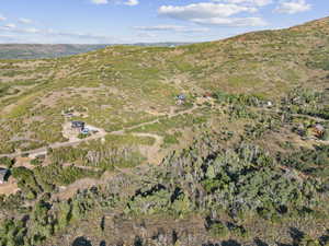 Aerial view of property's location featuring a mountainous background