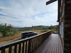 Wooden deck featuring a forest view