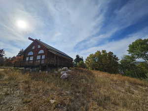 View of side of home with a deck and a sunroom