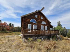 Back of house featuring a wooden deck