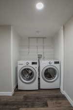 Laundry room with a textured ceiling, dark wood finished floors, and independent washer and dryer