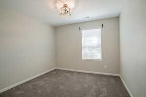 Unfurnished room featuring carpet flooring and baseboards