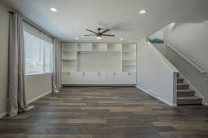 Unfurnished living room with ceiling fan, stairway, recessed lighting, dark wood-type flooring, and a textured ceiling