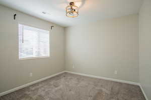 Unfurnished room featuring carpet floors and baseboards