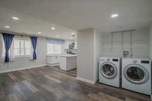 Laundry room with recessed lighting, dark wood-style floors, a textured ceiling, and separate washer and dryer