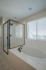 Full bath featuring a stall shower, a garden tub, tile patterned flooring, and recessed lighting