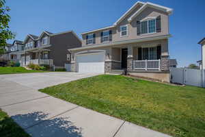 View of front facade featuring a porch, stucco siding, concrete driveway, and stone siding