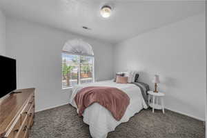 Carpeted bedroom with baseboards