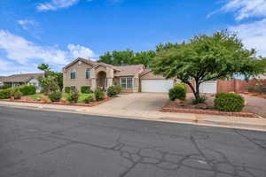 Mediterranean / spanish-style house featuring concrete driveway, stucco siding, a tile roof, and a garage