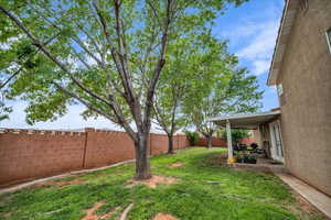 Fenced backyard with a patio area