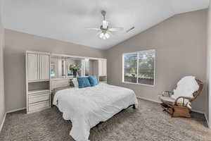 Bedroom featuring carpet, lofted ceiling, and ceiling fan