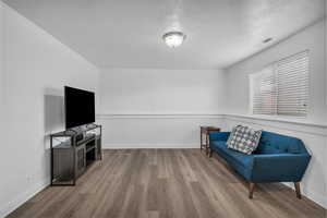 Sitting room with light wood-style floors and baseboards