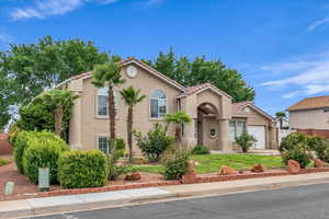 Mediterranean / spanish house featuring stucco siding, a tile roof, and a garage