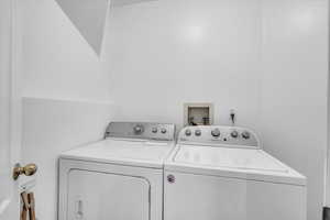 Washroom featuring independent washer and dryer